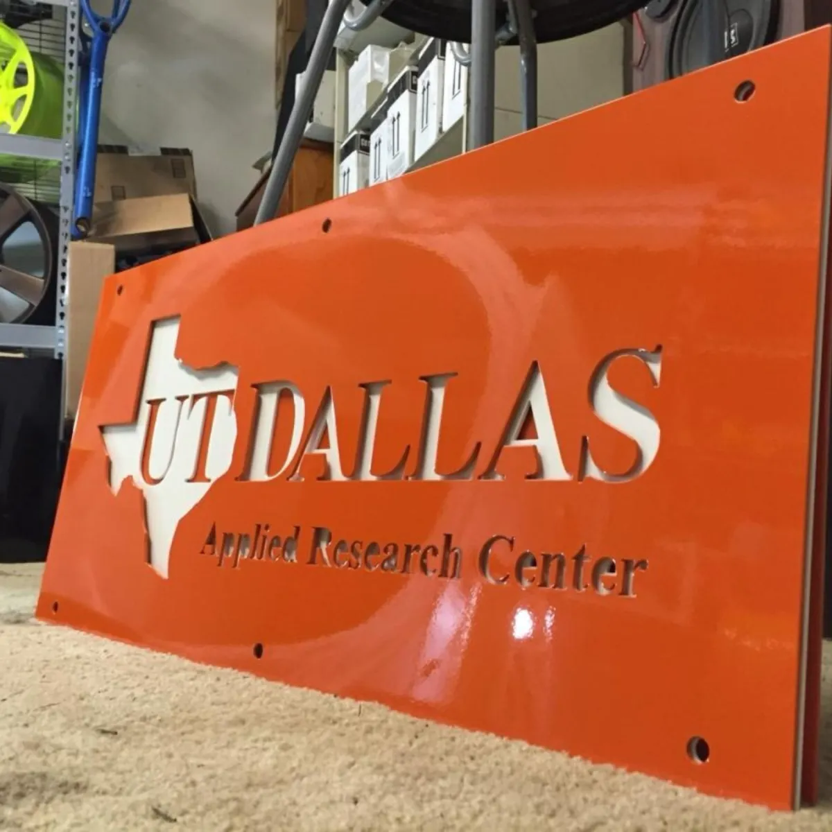 Laser-cut sign for the UT Dallas Applied Research Center in gloss orange.