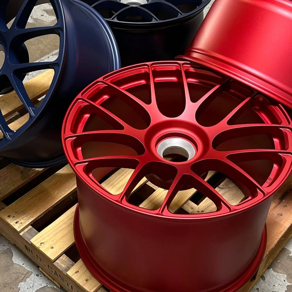 Porsche center lock wheels refinished in Avery Blue Metallic and Pyro Red