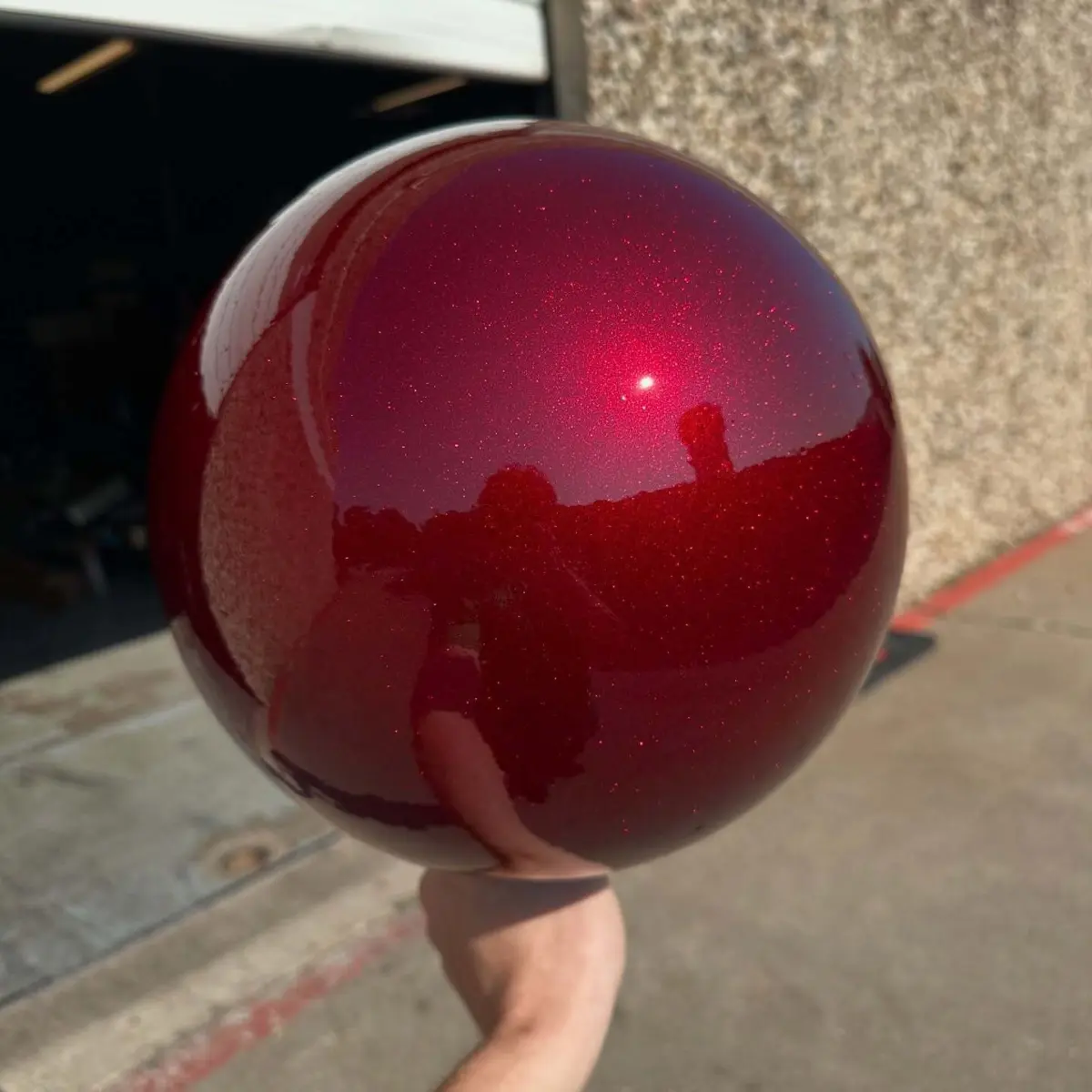 Sphere accent for an outdoor sculpture powder coated in a three stage red sparkle