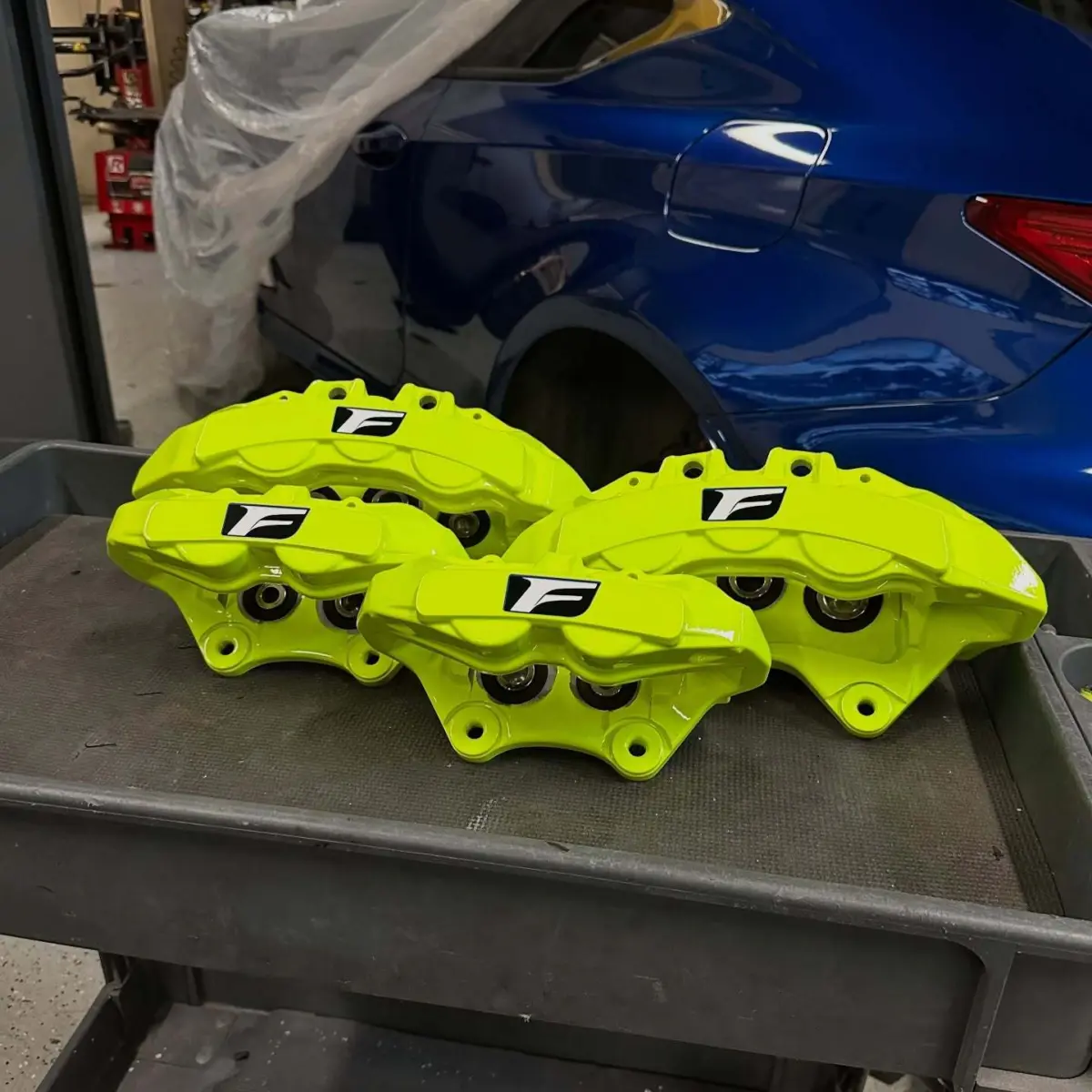 Lexus RCF brake calipers refinished in Neon Yellow with High Gloss Clear