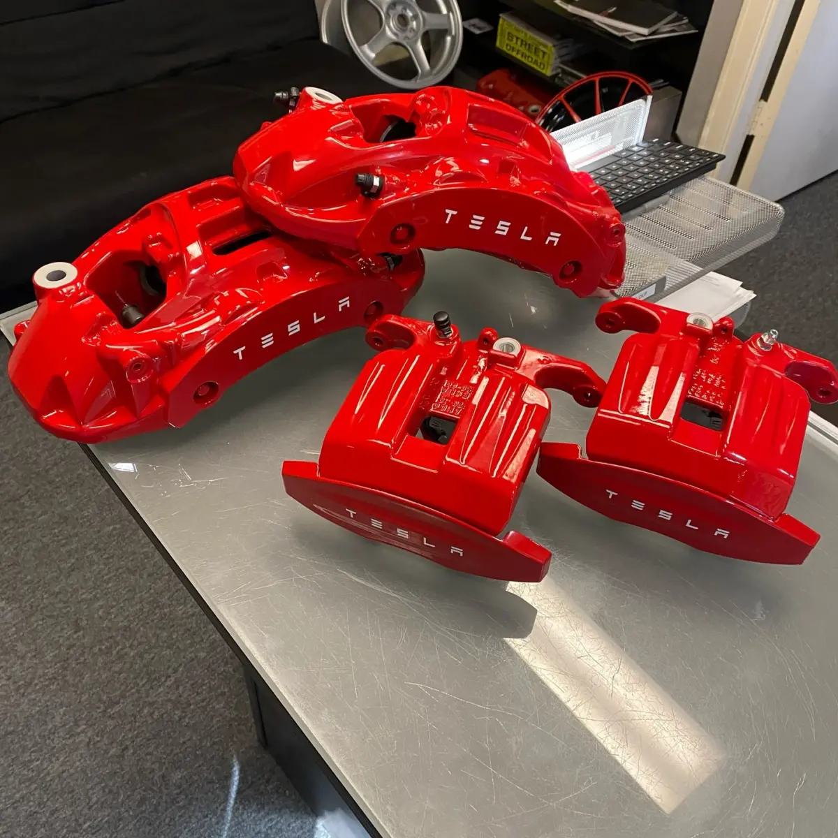 Tesla brake calipers powder coated in OEM red