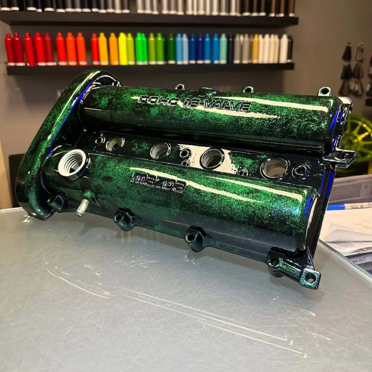 NA Miata valve cover powder coated in a custom emerald sparkle and black finish