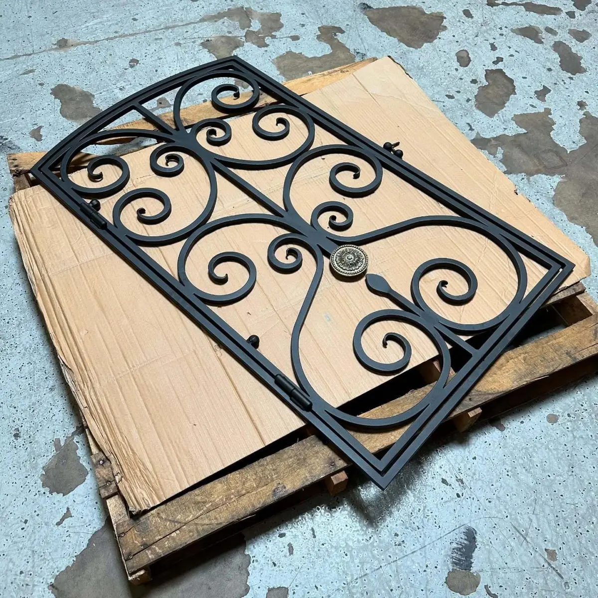 Door grate chemically stripped, sandblasted and powder coated with a Zinc Primer and Texture Black top coat. Light polish on the medallion