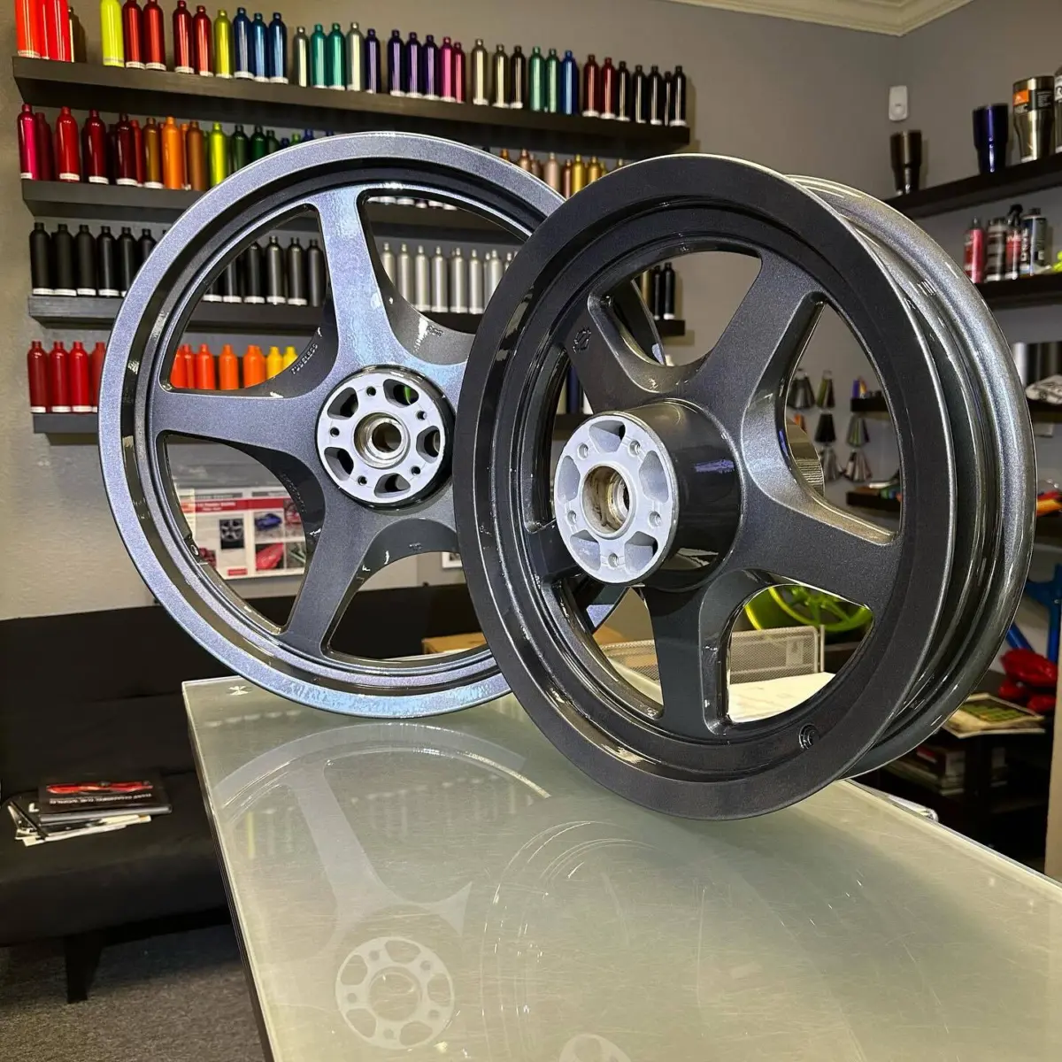 A second life for these chrome plated Harley Davidson wheels. These were sent off for reverse electroplating before sandblasting and powder coating with a special outgas forgiving primer, 929 gunmetal, and high gloss clear