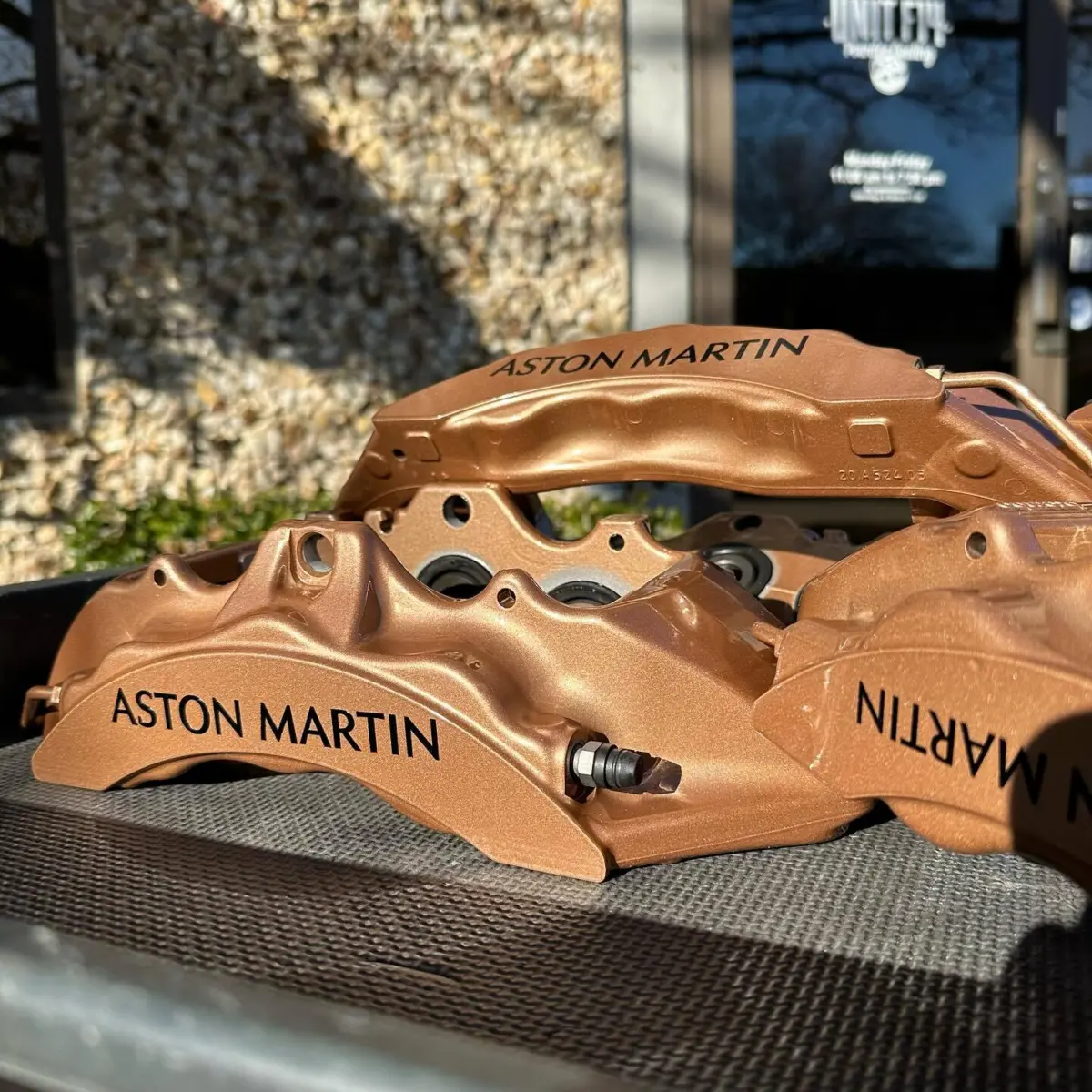 Aston Martin brake calipers shipped in from North Carolina rebuilt and powder coated in Metallic Copper with High Gloss Clear