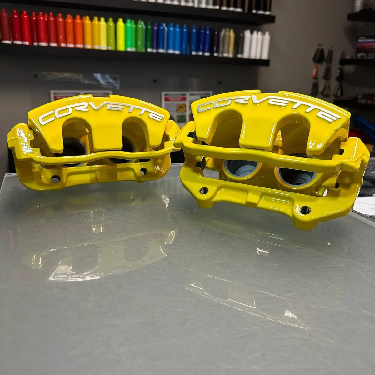 Corvette brake calipers rebuilt and powder coated in Hot Yellow with brushed logos