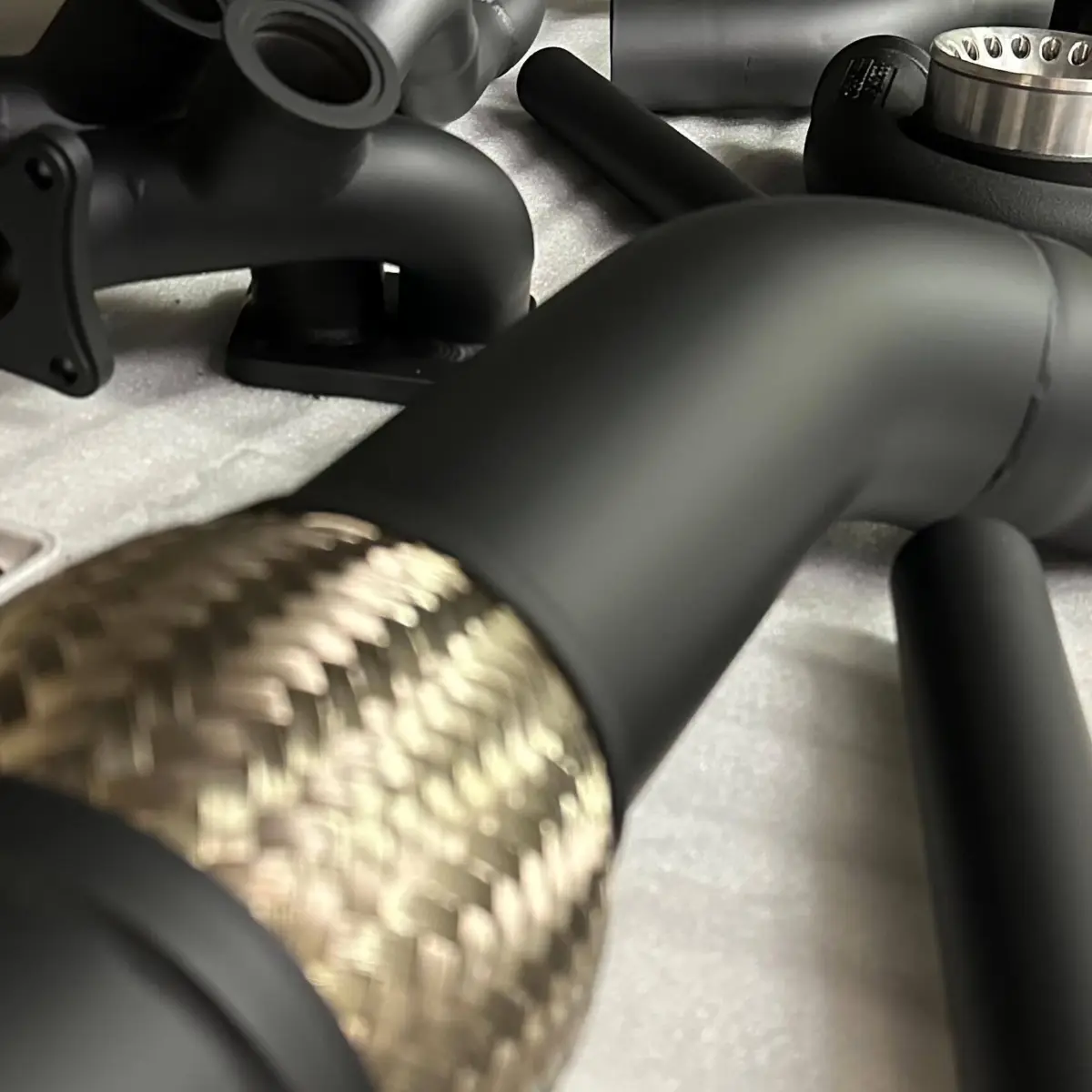 Exhaust parts refinished in Glacier Series Cerakote. Rated to handle temperatures up to 1800 and advertised as a better thermal barrier than any other coating on the market