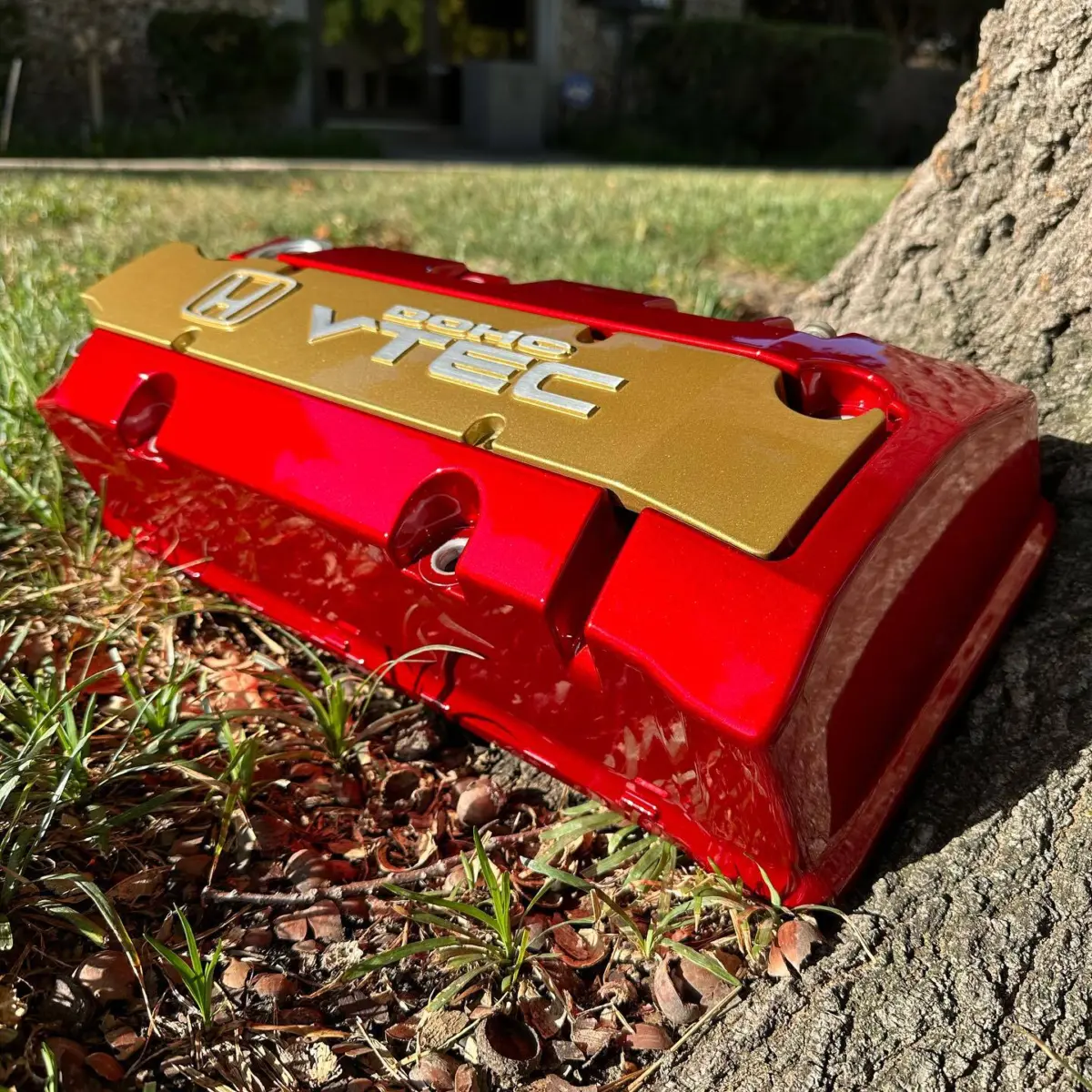 Valve cover refinished in Lollipop Red over Bengal Silver with coil cover in Starbrite Gold with brushed logos