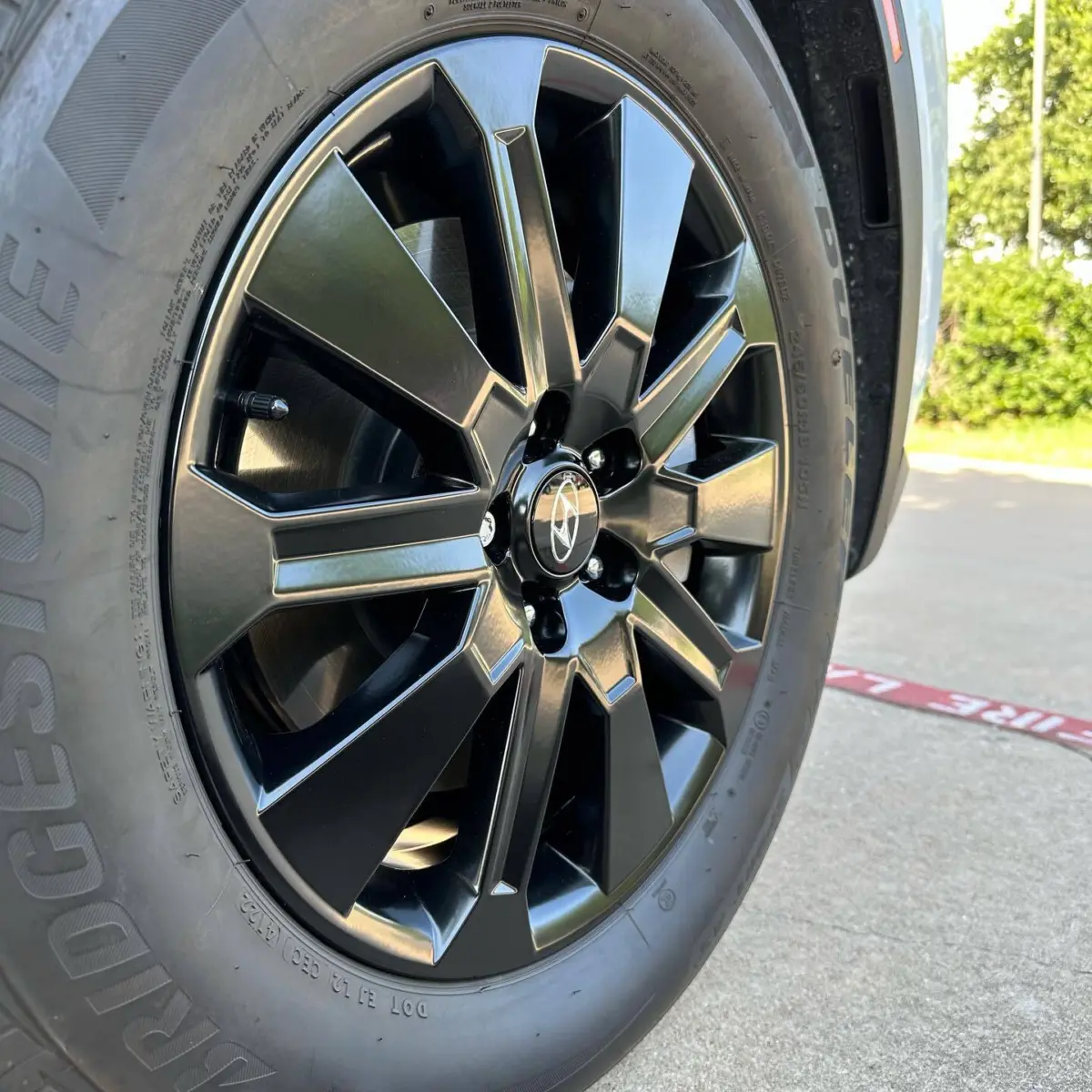 Hyundai Palisade wheels powder coated Semigloss Black. All vehicles are stored indoors, wheels are chemically stripped and sandblasted before powder coating, and balanced with black wheel weights