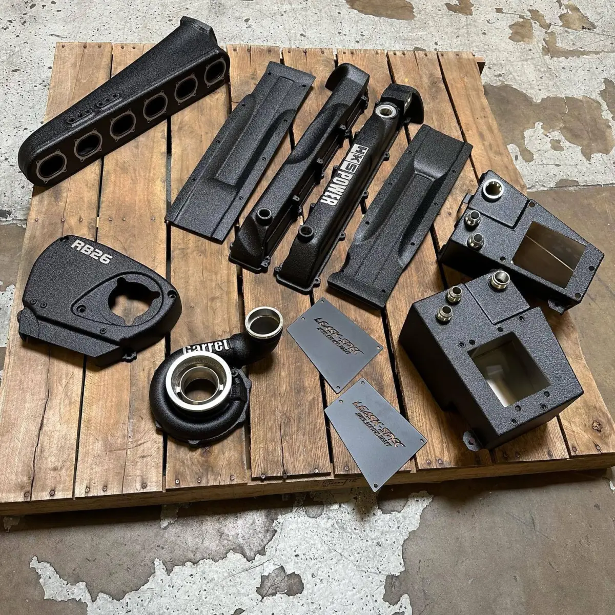 Wrinkle black. Everything was stripped to bare metal, critical surfaces were masked before sandblasting, and masked again before powder coating. Logos are masked and finished with a final brush