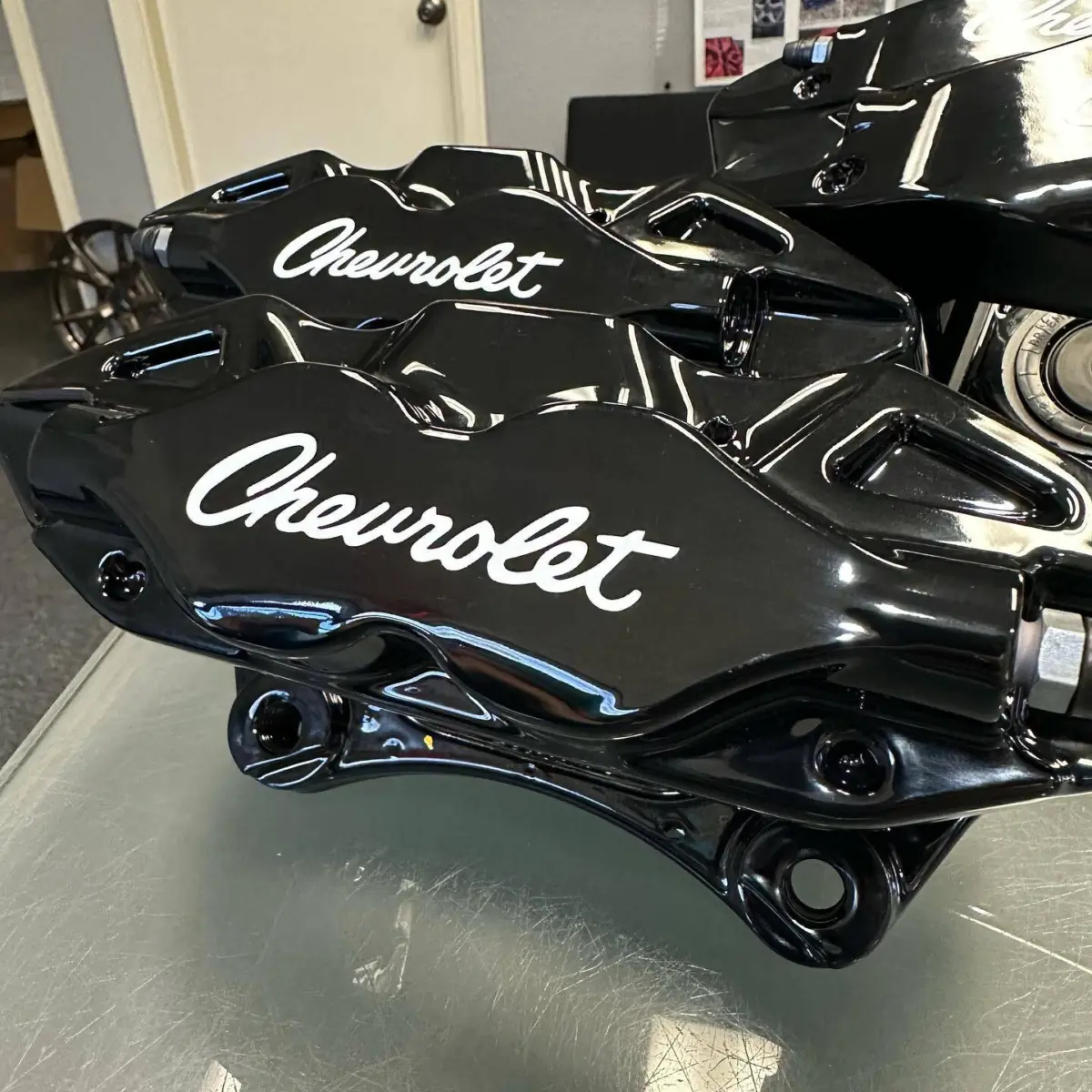 Brake calipers rebuilt and powdercoated in Super Mirror Black with custom Chevrolet Script logos