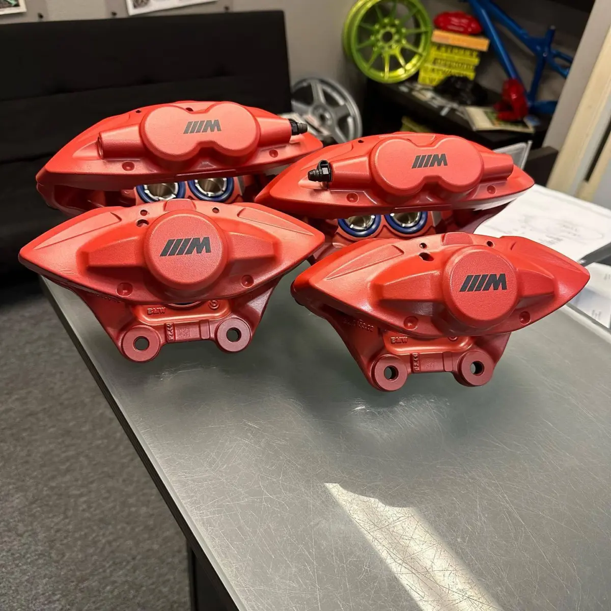 BMW brake calipers rebuilt and refinished in Habenero Red Cerakote for track use. Powder coating is the best option for refinishing brakes for street use where they will not see temperatures above 225 Fahrenheit. This particular cerakote finish