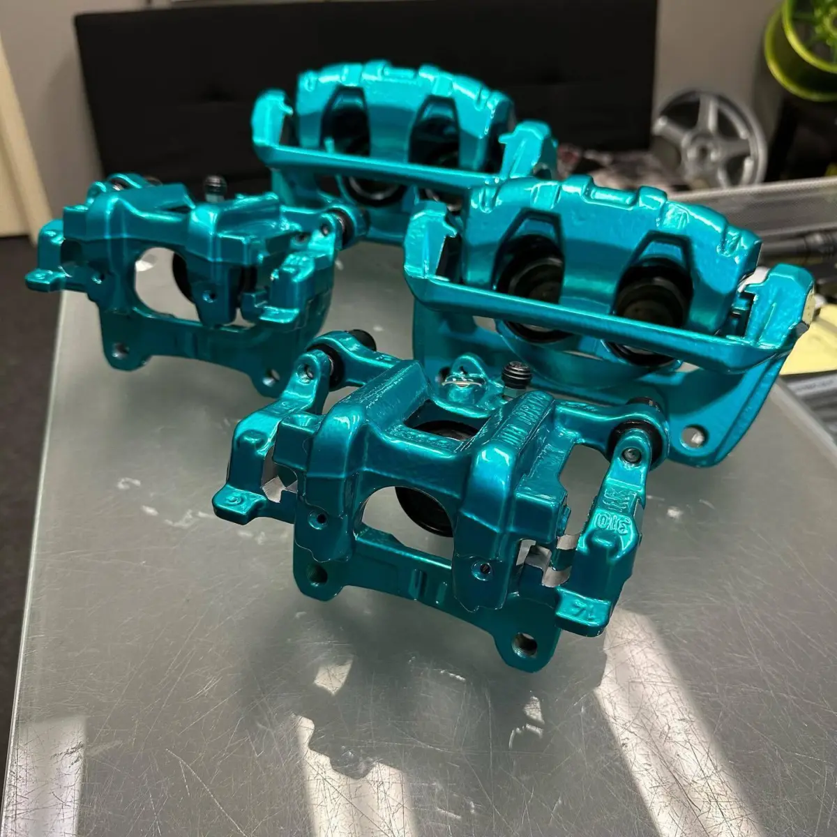 Acura TL brake calipers refinished in Candy Teal