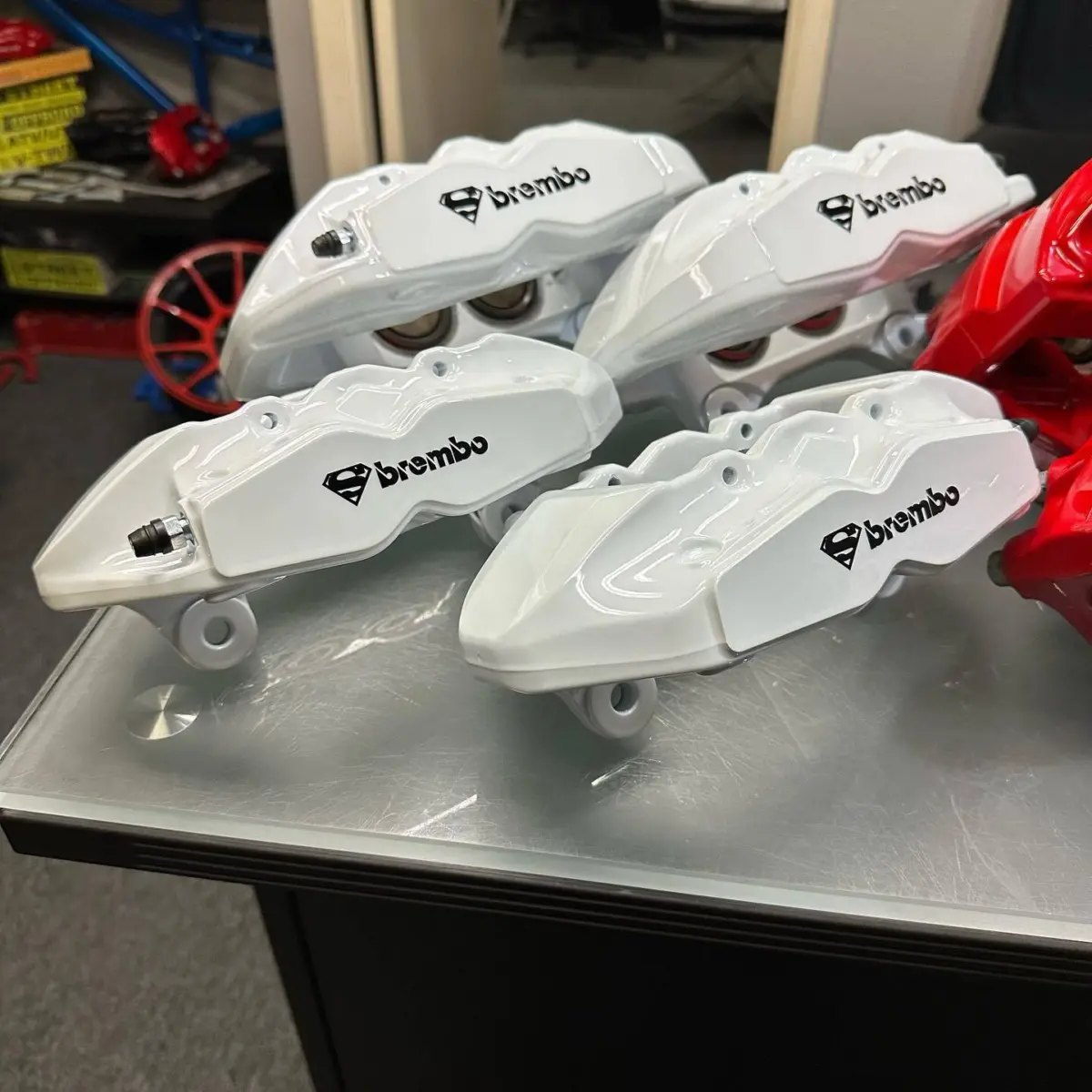 Genesis calipers refinished in Pearlized Violet with High Gloss clear. Infiniti q70 calipers refinished in House Red with High Gloss Clear. 2023 Mercedes SL55 AMG calipers refinished in Dark Metallic Gunmetal with High Gloss Clear. Mustang Roush