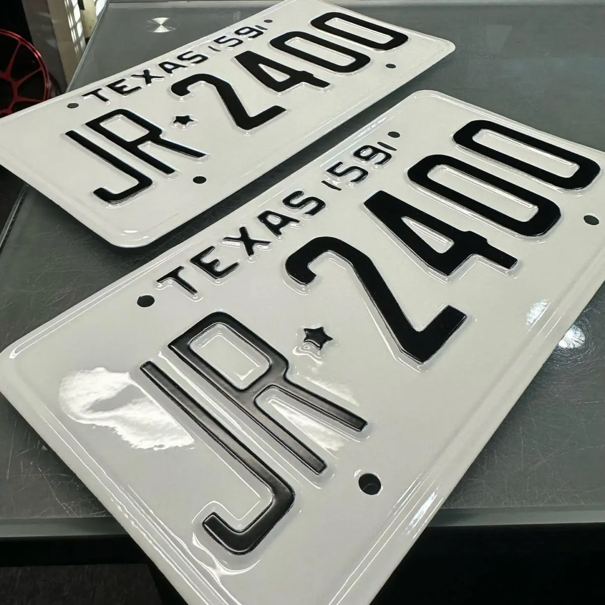 License plates refinished in Bengal White with Pac Car Black lettering