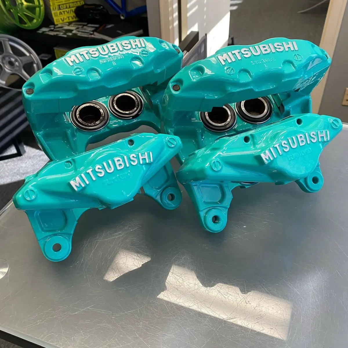 Mitsubishi 3000GT brake calipers refinished in Tropical Breeze with a High Gloss Clear and brushed logo