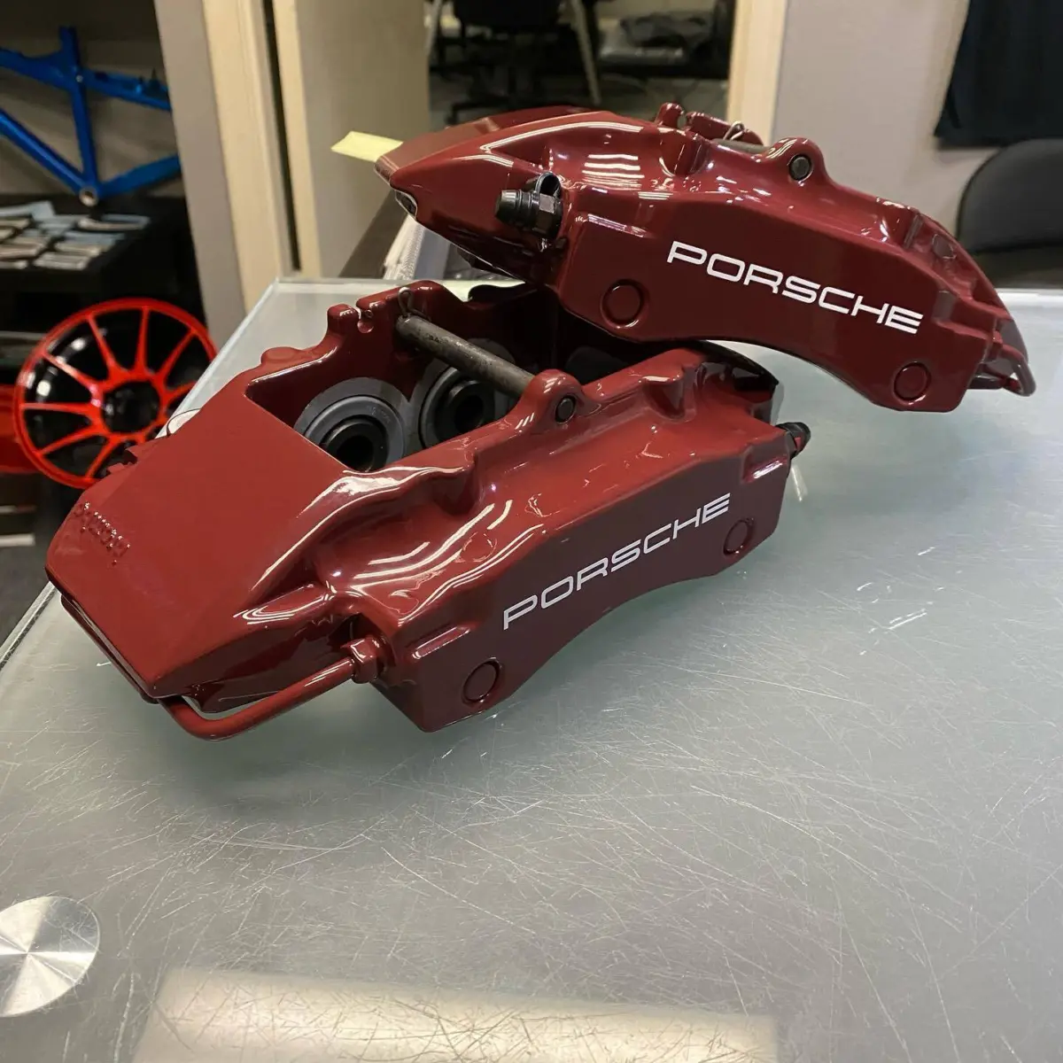 Porsche brake calipers refinished in Brandy Wine with High Gloss Clear