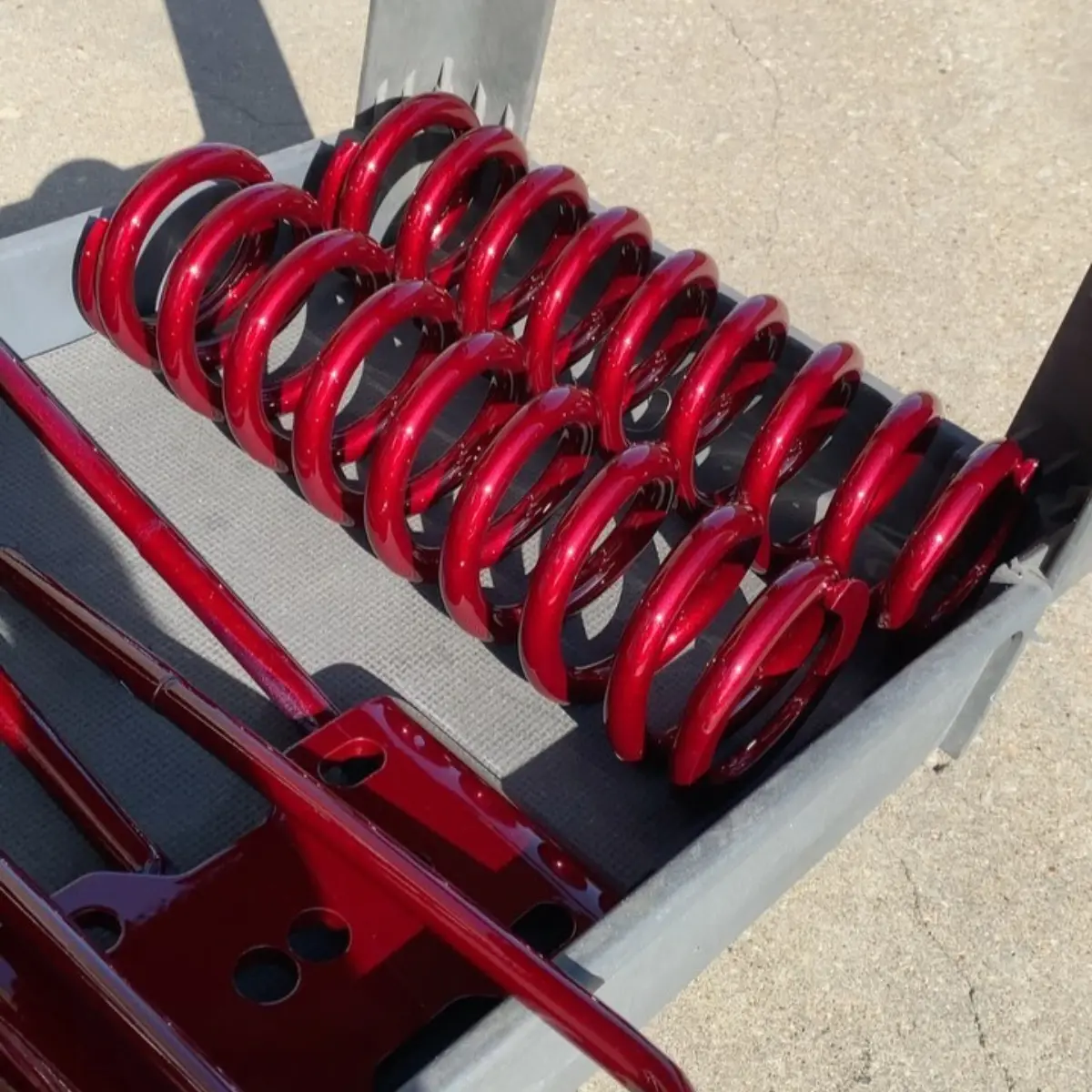 Lift kit refinished in @prismaticpowders Illusion Cherry. This color shifts from a deep dark red to a bright metallic finish in direct light!