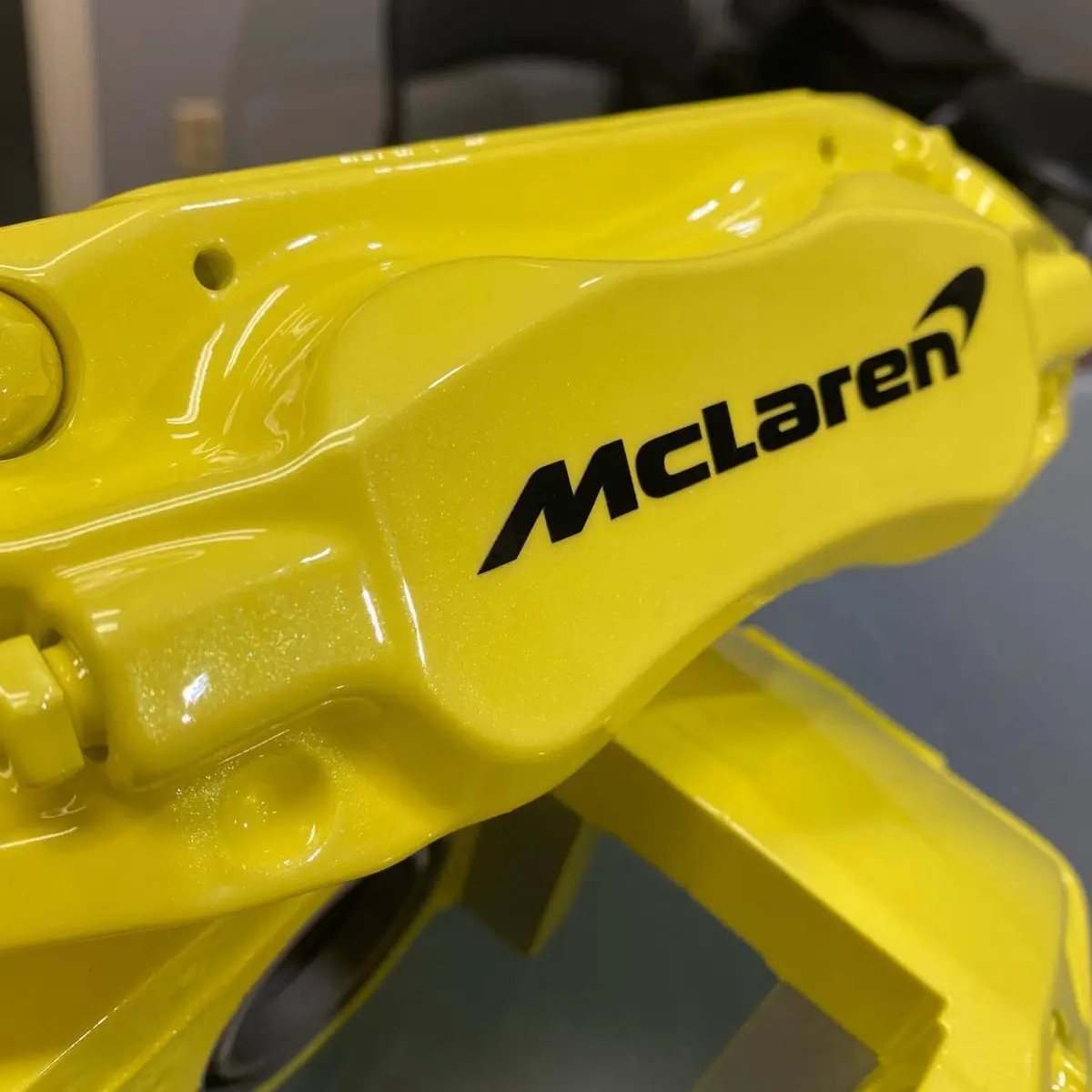 Mclaren brake calipers refinished in Lemon Meringue with High Gloss Clear