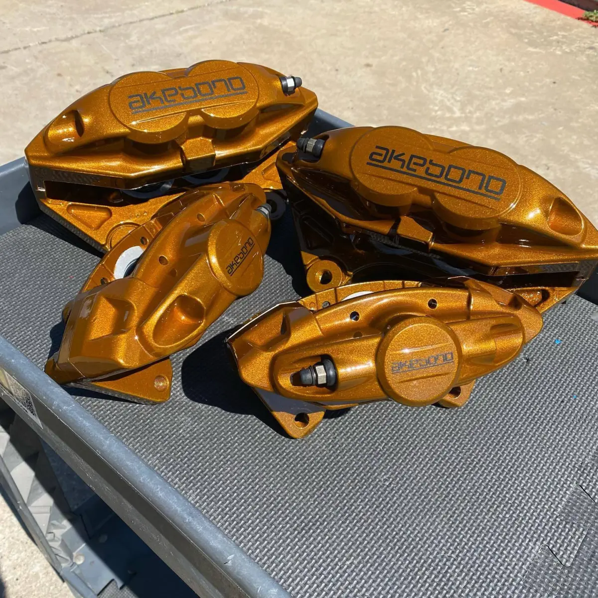 Akebono brake calipers refinished in @prismaticpowders Illusion Spanish Fly