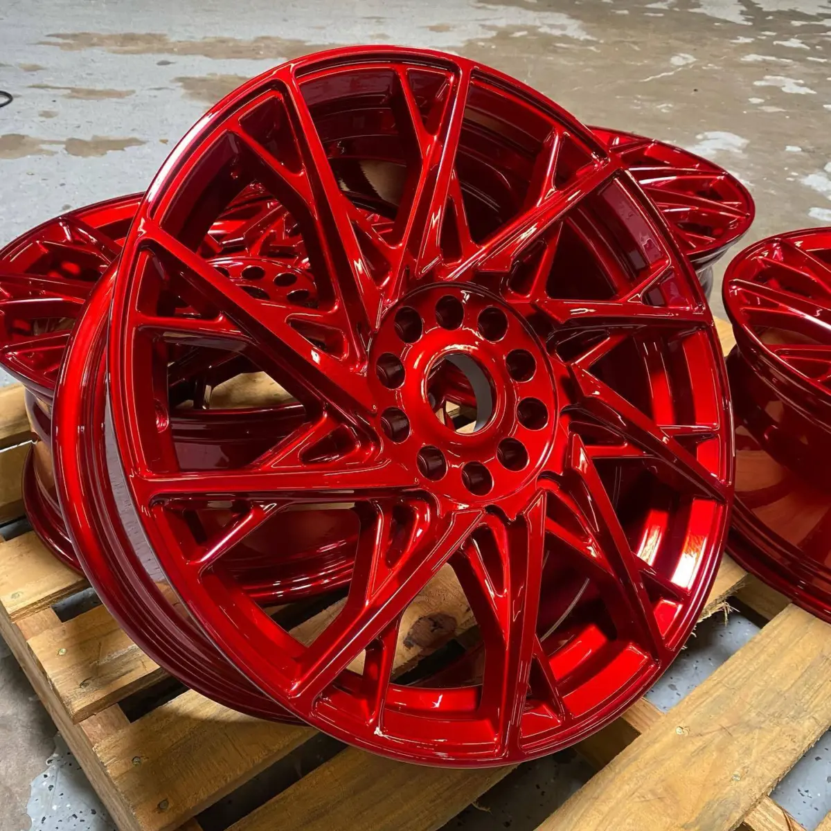 Wheels refinished in a 3-stage candy red. Chrome base coat, transparent mid coat, topped with a high gloss clear