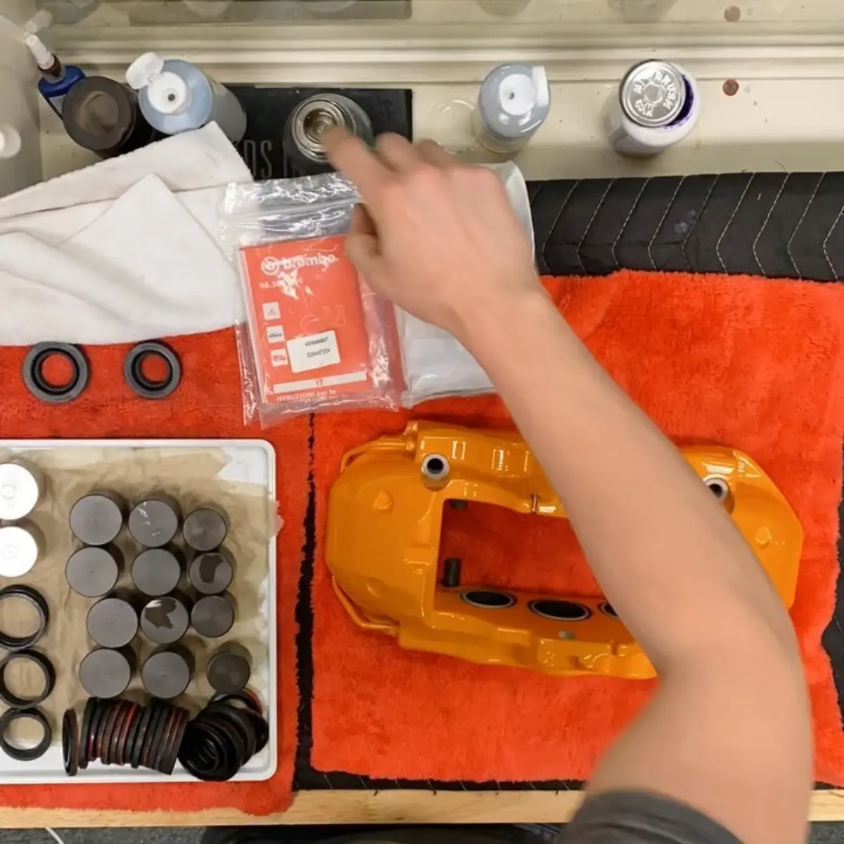 Rebuilding a set of Lamborghini Huracan brake calipers, refinished in a metallic golden orange for @majestic_huracan