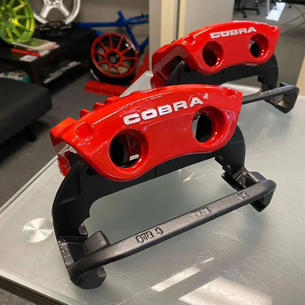 Mustang brake calipers refinished in Richard Red with brushed logos and Denim Black carriers