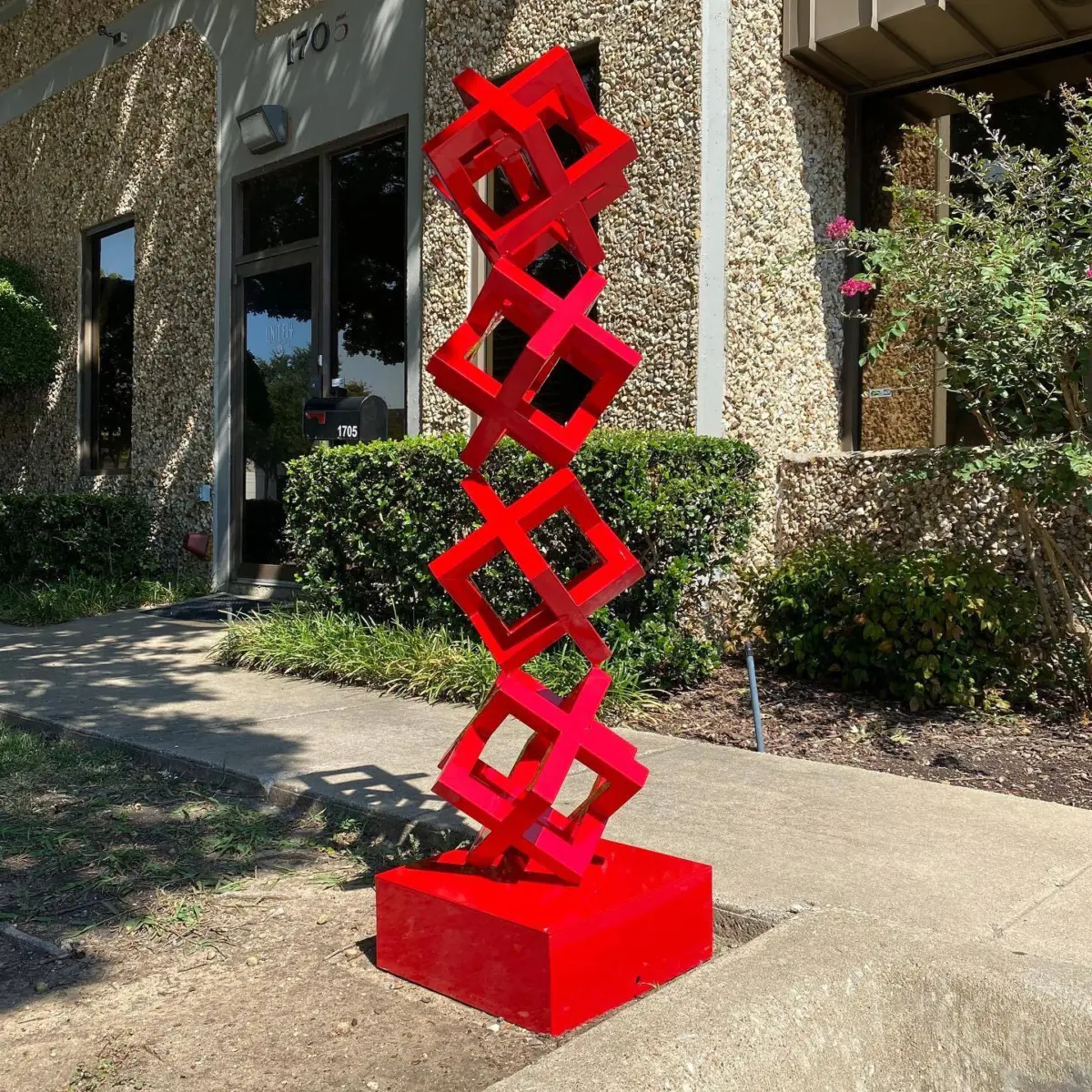 Metal sculpture refinished in a bright red