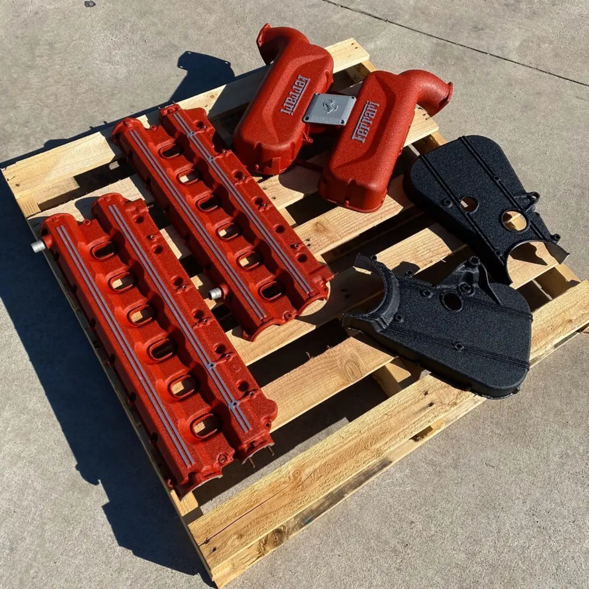 Ferrari Testarossa valve covers and timing covers pictured with an Intake from a 360 Modena refinished in Wrinkle Red, Black, and Rhino. Finished with brushed accents