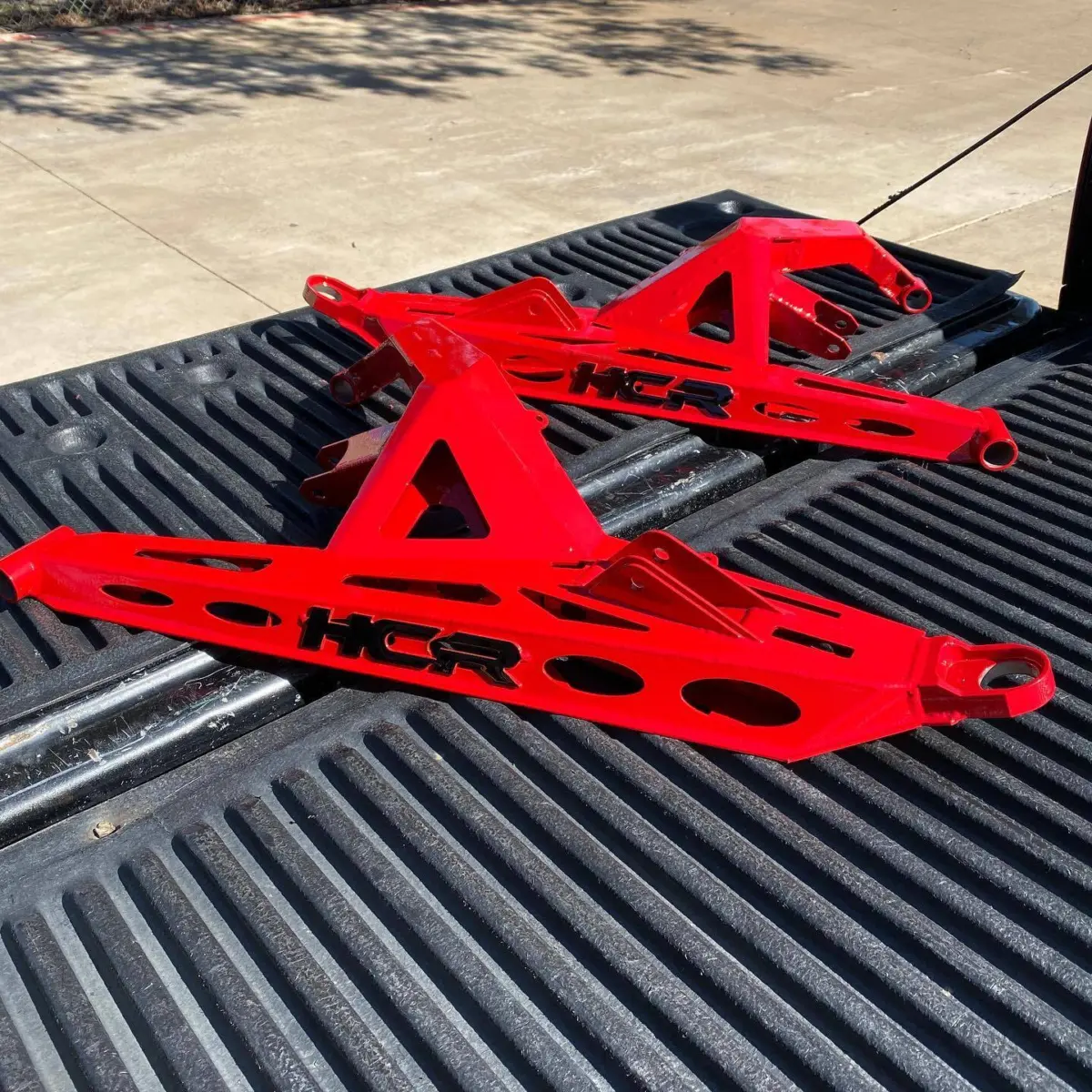 HCR Racing UTV control arms refinished is Cardinal Red with Gloss Black accents
