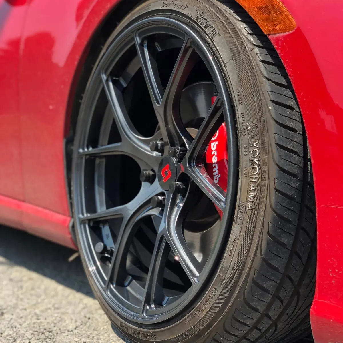 Subaru BRZ wheels refinished in a Dark Metallic Gunmetal with High Gloss Clear and red accents on the center caps
