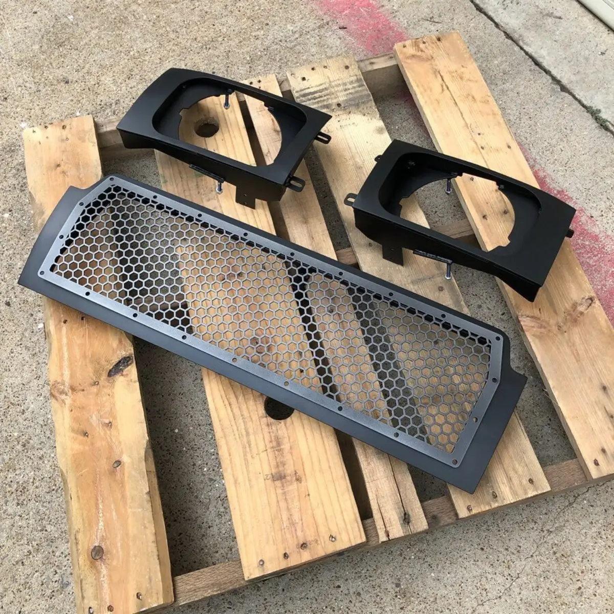Grill and headlight buckets refinished in Texture Black and Satin Gunmetal