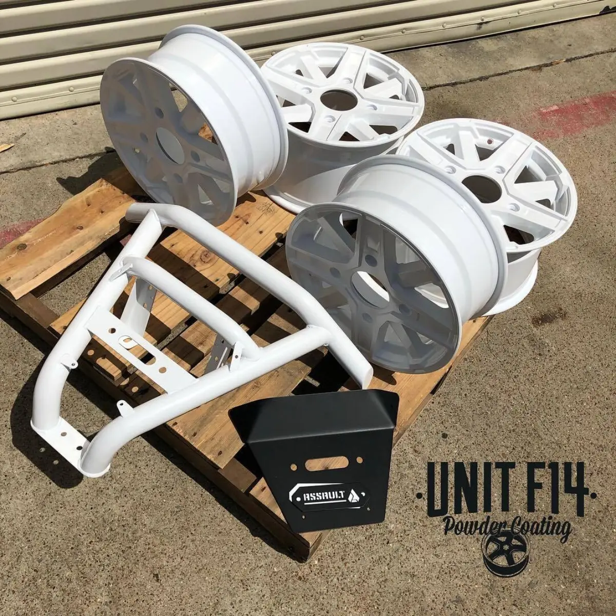 ATV parts refinished in High Reflective White and Denim Black powder coat