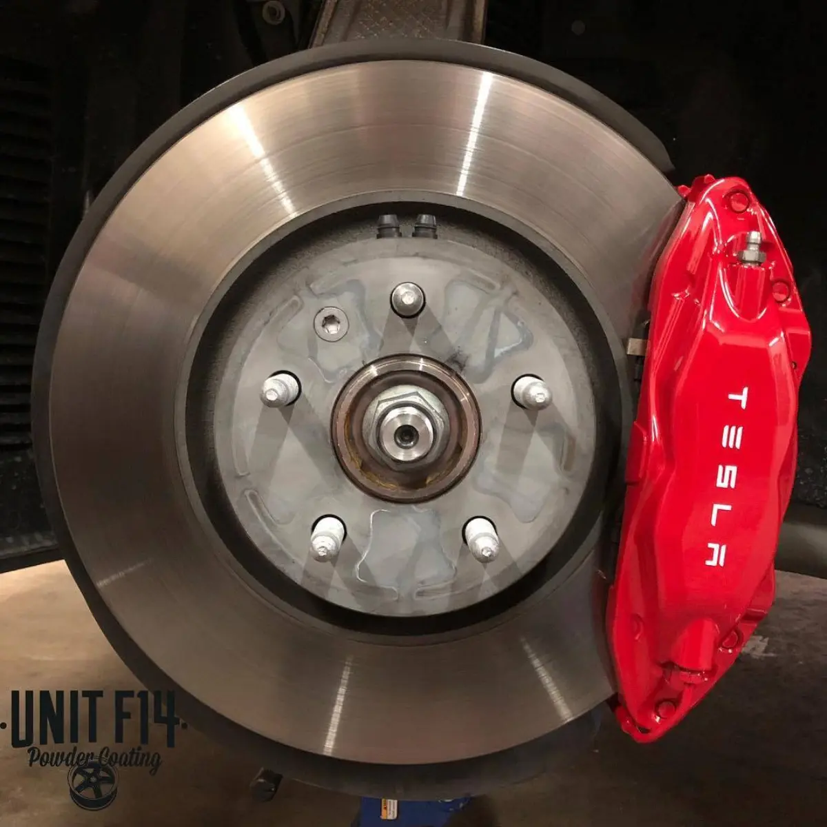 Tesla Model S brake calipers powder coated in “Brembo” red