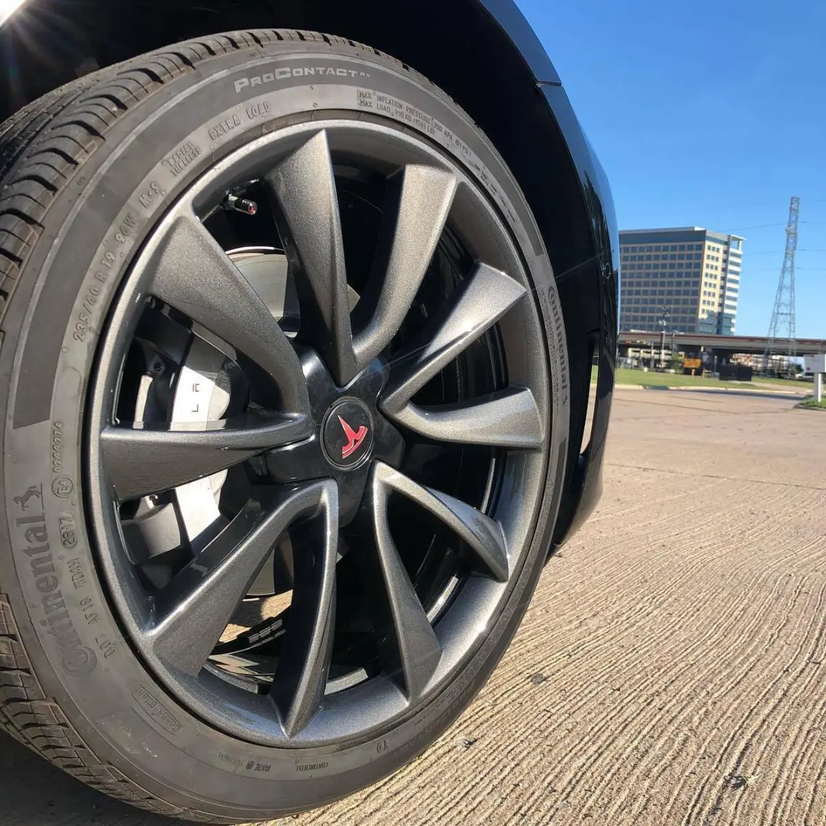Tesla wheels refinished in a dark metallic gunmetal