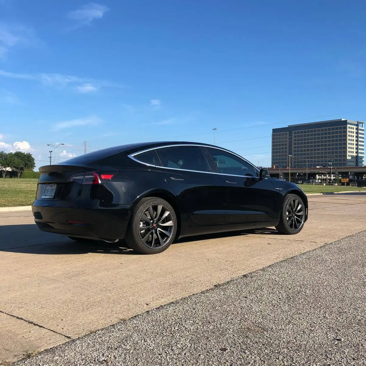 Tesla wheels refinished in a dark metallic gunmetal