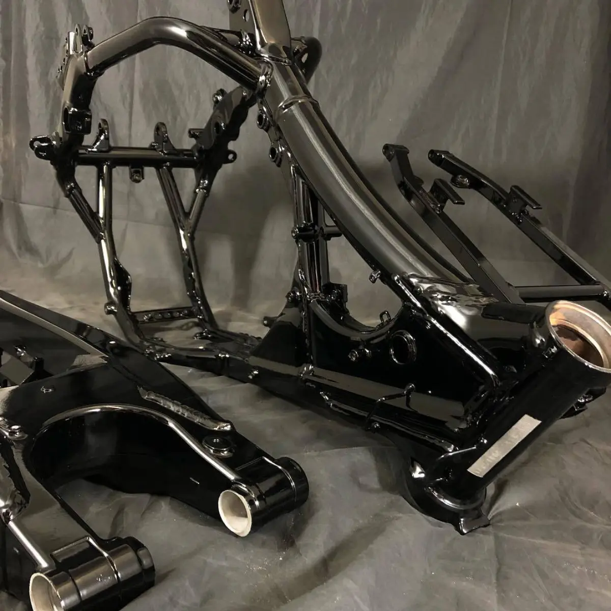 Dirt bike frame in Wet Black with a zinc primer