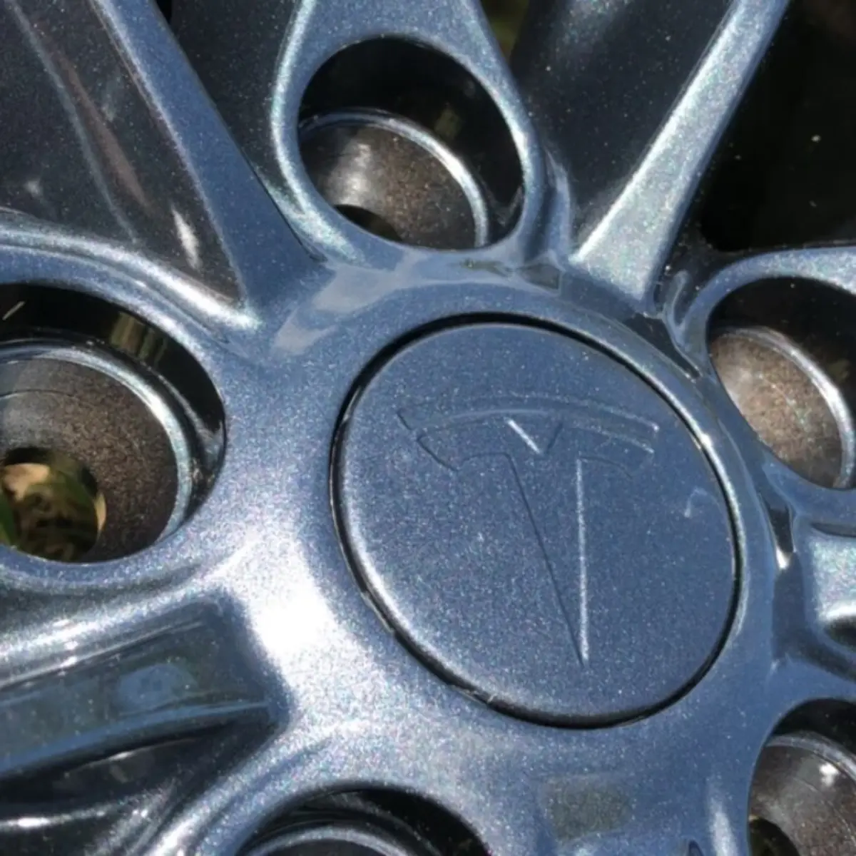 Tesla wheels refinished in a colorful metallic gunmetal