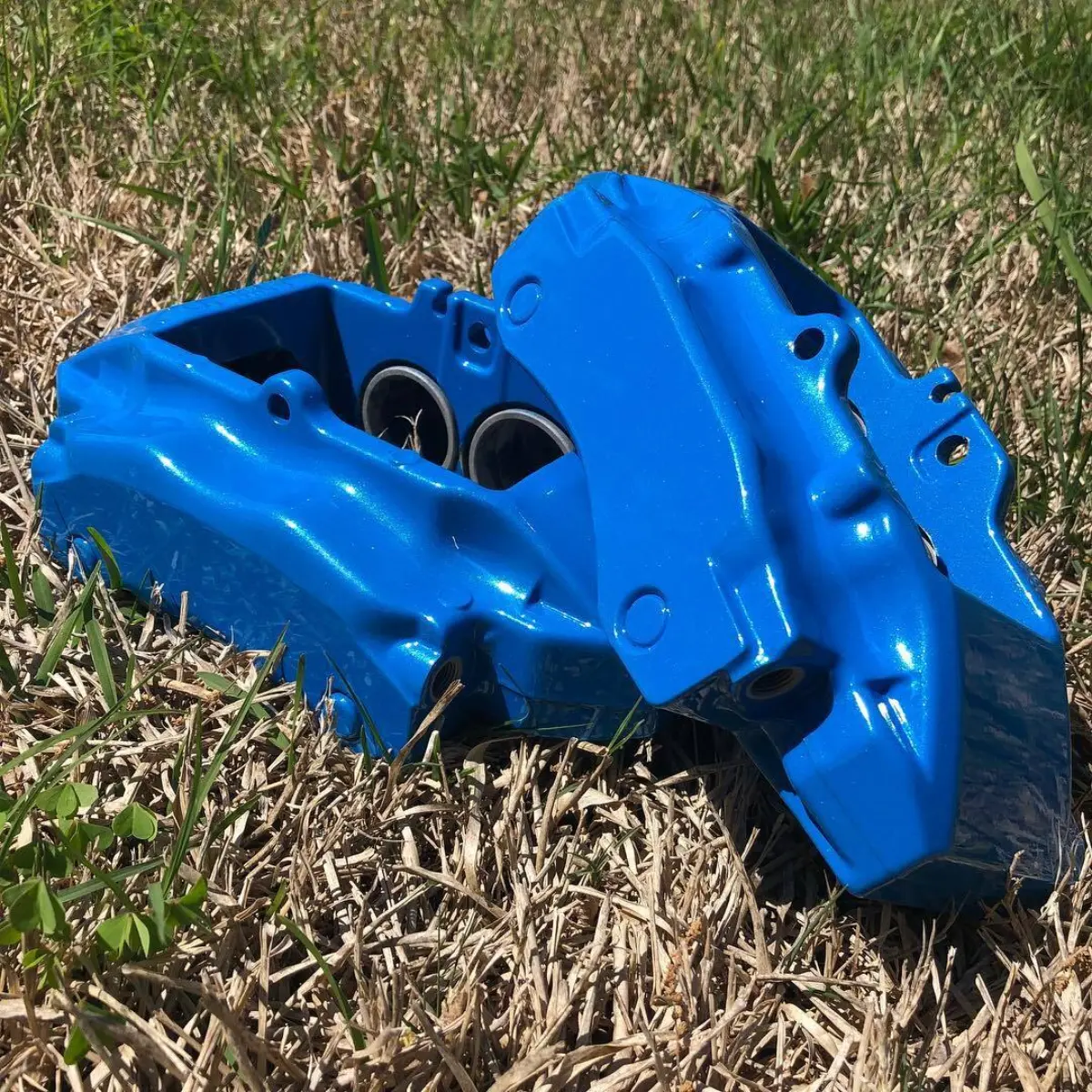 A set of Porsche calipers in metallic light blue