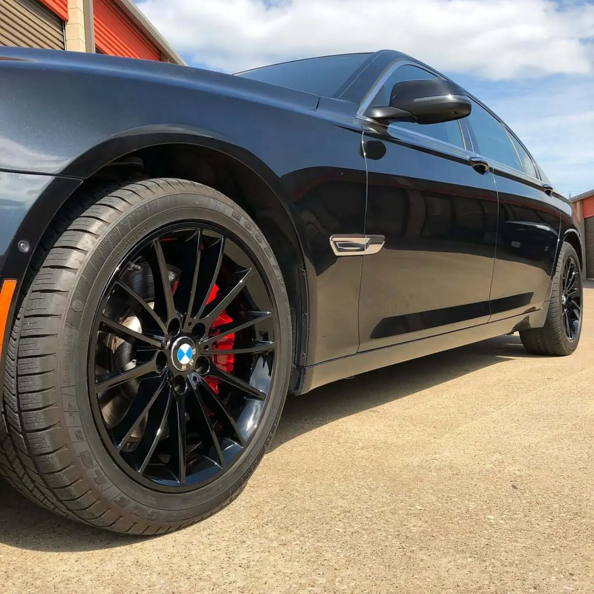 BMW 750li wheels in wet black and calipers in our house red with high gloss clear