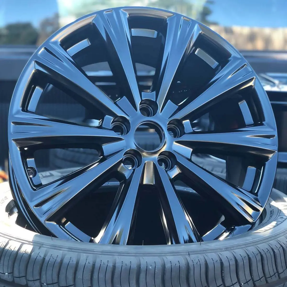 Ford Escape wheels powder coated in Semigloss Black. Topped off with black lug nuts and black wheel weights