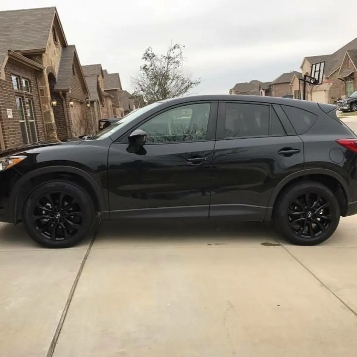 Mazda CX-5 with Wet Black wheels. Ask about our black lug nut upgrade!