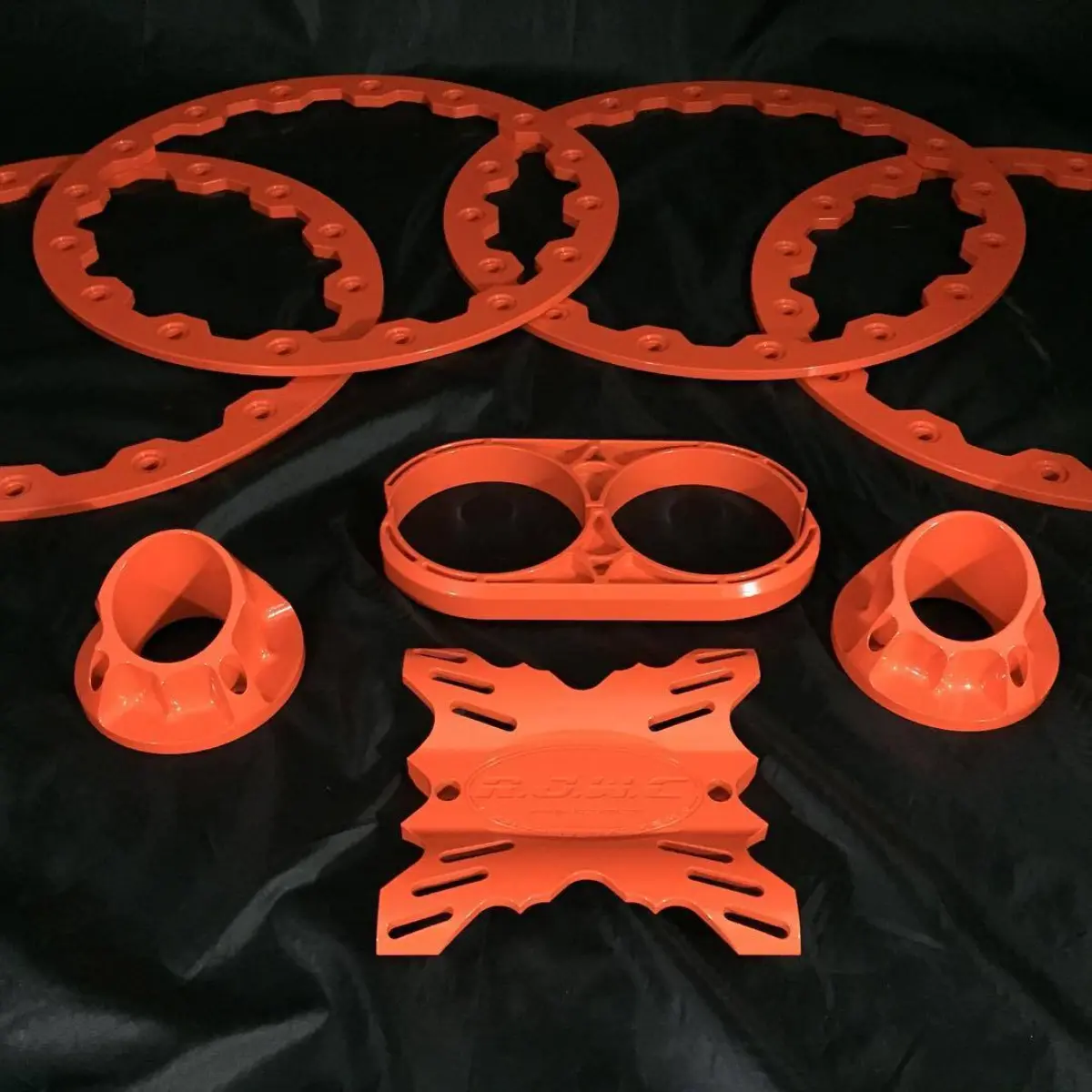 Set of bead locks and an exhaust mount in RAL 2004