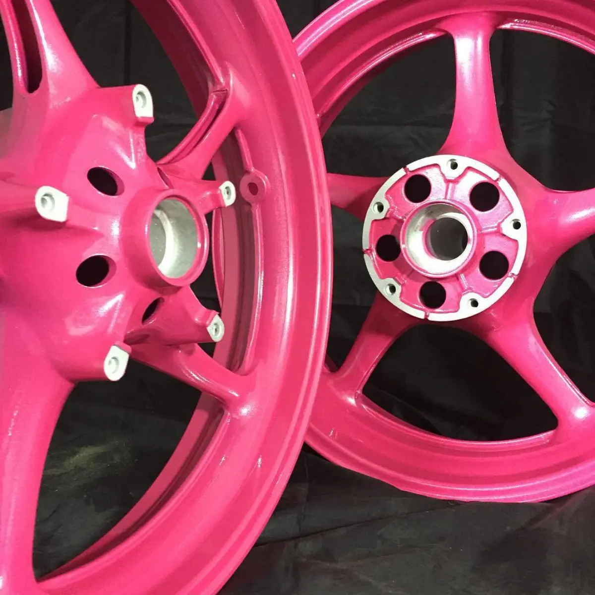 Pink motorcycle rims with a rainbow clear