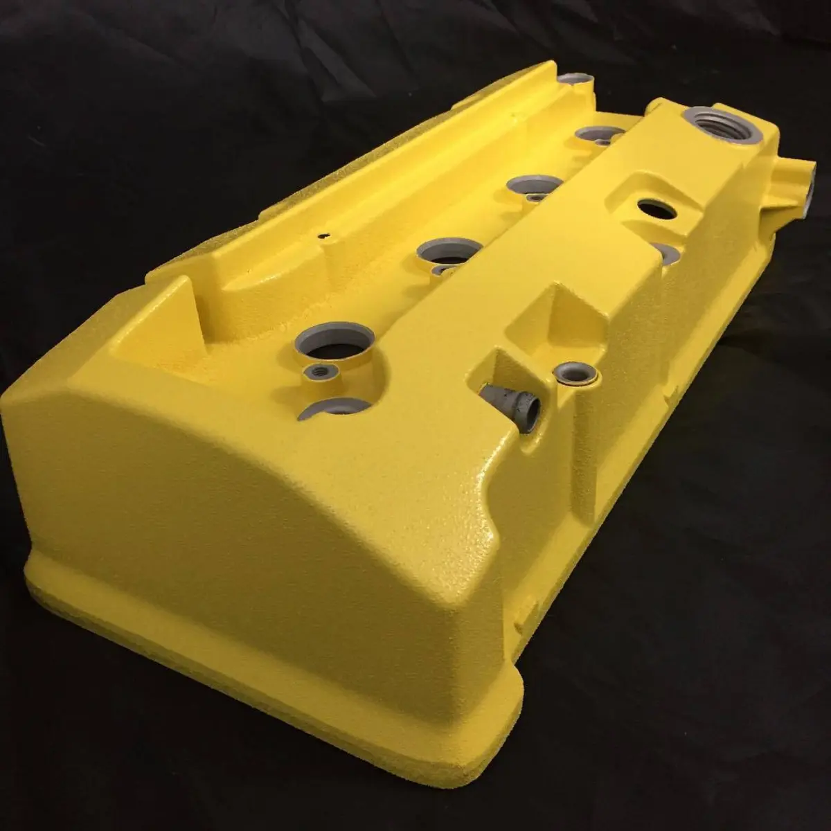 This valve cover is yellow. Sport spoon yellow with heavy texture