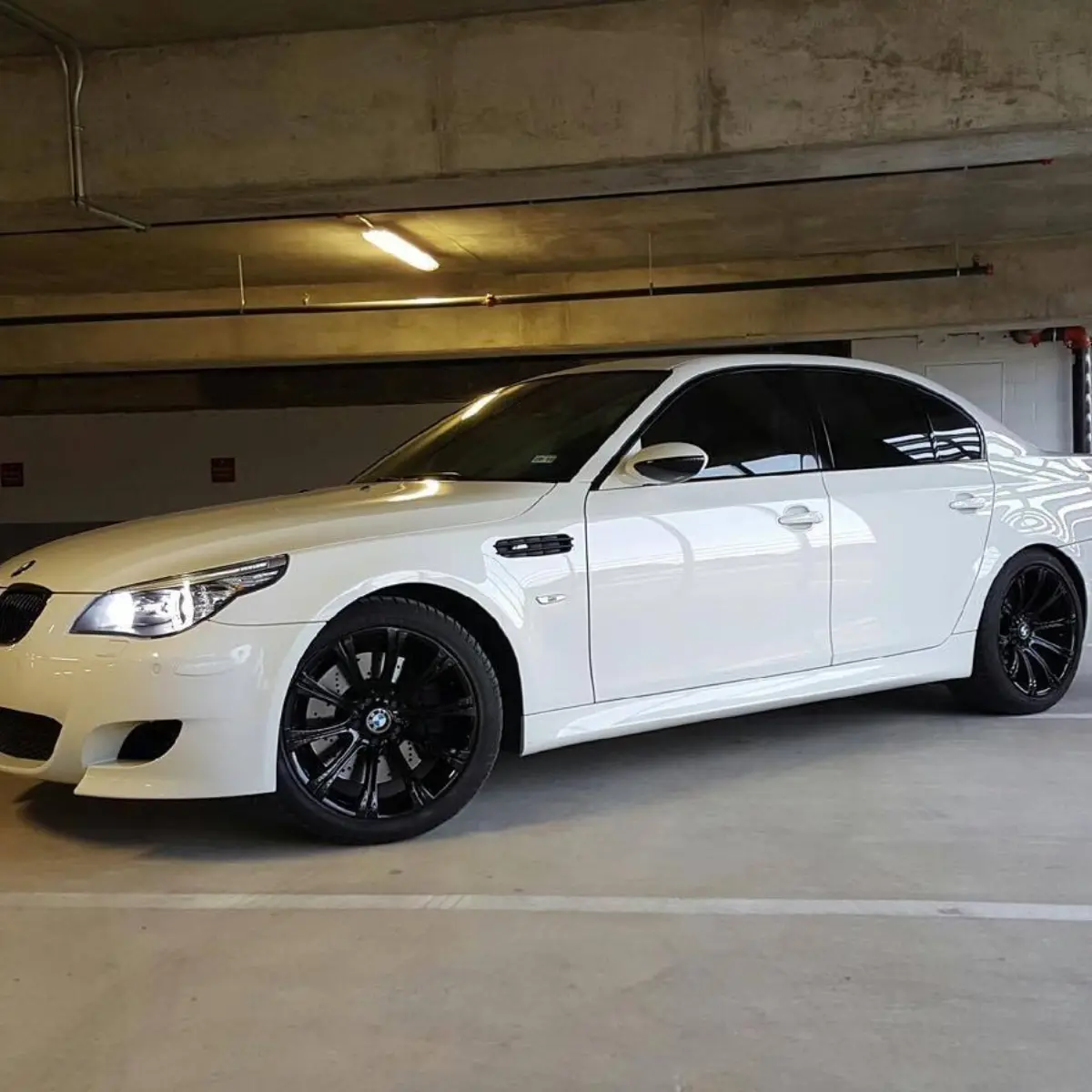 Gloss black always looks sweet on white! Another BMW M5 owner took advantage of our home wheel service!