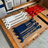 Flag wrench sculptures sandblasted and powder coated in Bengal White, Bengal Red, and Sapphire Blue with High Gloss Clear