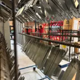 Large run of gutter brackets powder coated in RAL 3031 custom matte finish