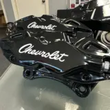 Brake calipers rebuilt and powdercoated in Super Mirror Black with custom Chevrolet Script logos